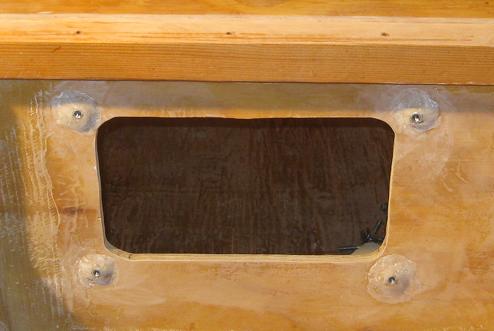 Four nuts set in a mixture of epoxy and wood flour against the inside of the bulkhead
