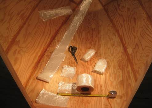 Fiberglass tape cut and laid at the ready to be applied