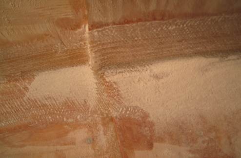 Sanding and feathering the edges of the fiberglass tape