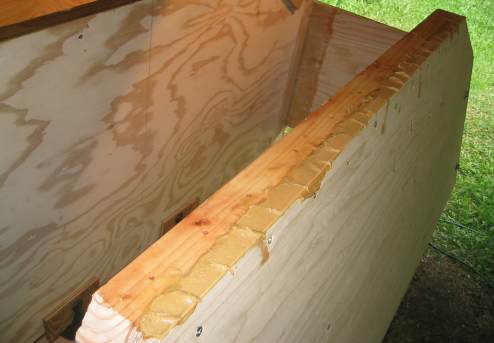 Applying epoxy and epoxy paste to transom bottom frame piece