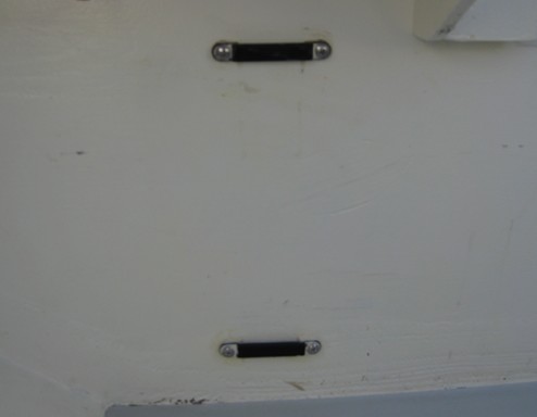 The strap holding the battery box in place goes through these through-bolted stainless sleeves on the bulkhead