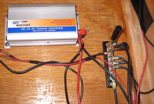 On the inside of the cabin, a negative bus bar is bolted high up on the bulkhead