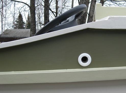 The hose connects to a nylon through-hole that exits the cabin sides just above the 
rub rail