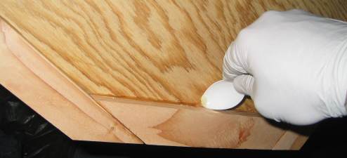 Scraping excess epoxy with a spoon