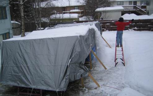 Snow falling from tarp as I pull it off