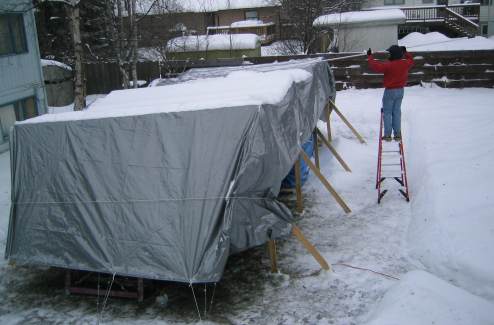 Pulling snow off tarp with roof snow removal tool