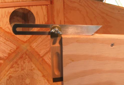 Using a bevel square to get the angle of the roof line.