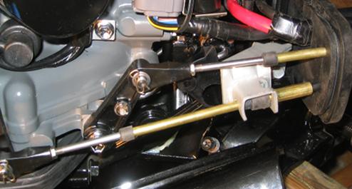 The top control cable goes to the forward/ reverse shifter, and the bottom one goes to the carburetor