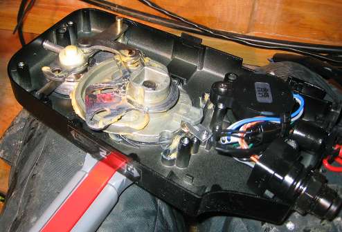 The throttle cable and the shift cable	are being connected to the throttle housing