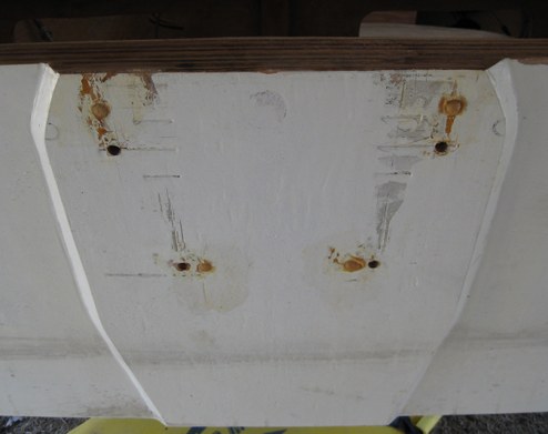 I removed the outboard and plugged the mis-drilled holes with a slurry of epoxy and 
wood flour