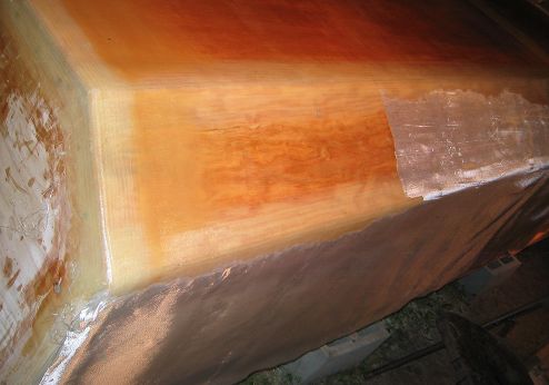 The cloth on the right side is being wetted out with epoxy