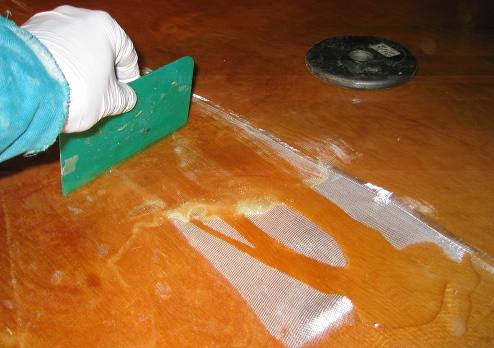 Moving the epoxy around with a spreading blade