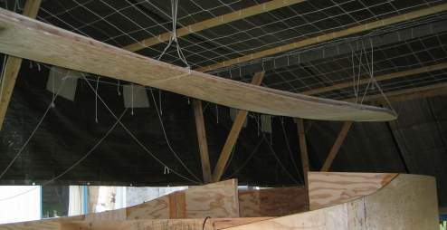 Bilges hanging out of the way above the partially assembled boat