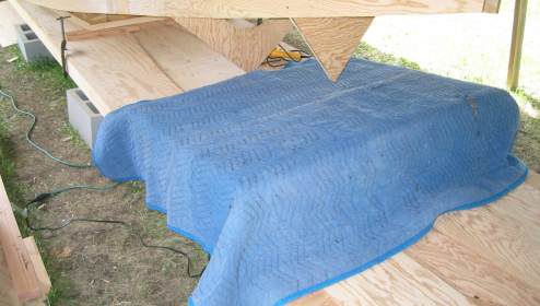 Heat applied to bilge butt joint under erected sides
