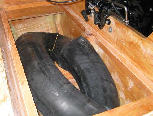 The transom well is framed out for the rear deck plate, and a truck inner tube is providing temporary floatation