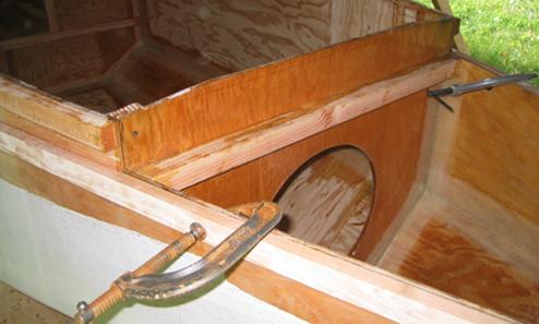 Beginning to attach the first layer of the rub rail near the bow