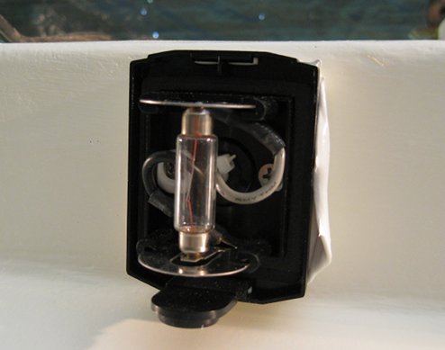 The light (lens cap is off) is bedded in sealant, and screwed to the extender block 
with stainless screws