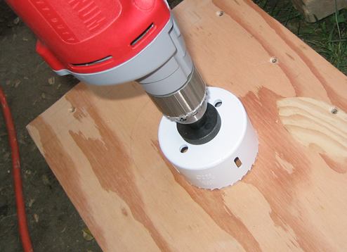 Drilling the hole to the right size for the steering gear with a hole saw