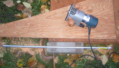 Routed out a slot lengthwise 5/8th-inch square to be able to recess the steel rod in the block of wood