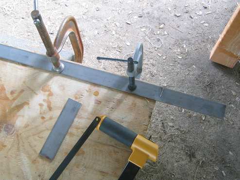 Cut two short lengths of mild steel to serve as backing for a custom u-bolt