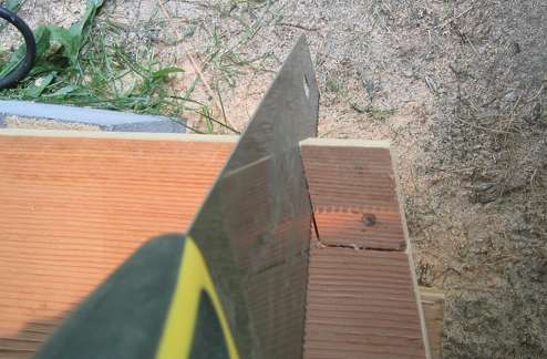 A notch is cut out of a 12-inch wide board to fit over the bottom transom frame
